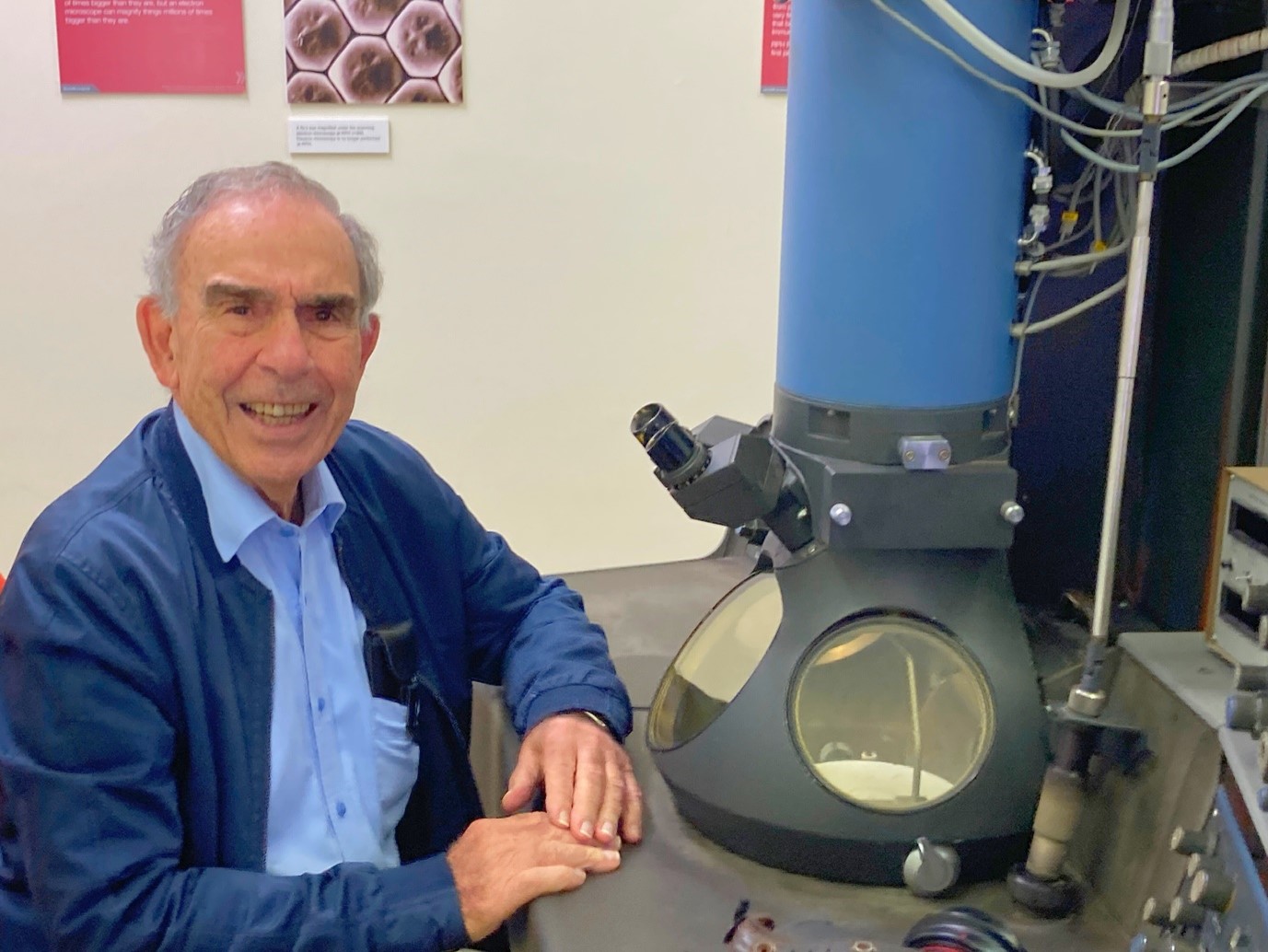 Photograph of Professor John Papadimitriou who worked on the microscope and was visiting the TEM exhibit.  